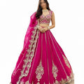 Glamourental fuchsia silk lehenga choli set with intricate beadwork, sequin embellishments, and designer dupatta.