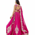 Glamourental fuchsia silk lehenga choli set with intricate white bead and sequin embroidery, tassels, and designer dupatta.
