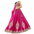 Glamourental fuchsia silk lehenga choli set with intricate white bead and sequin embroidery, tassels, and designer dupatta.