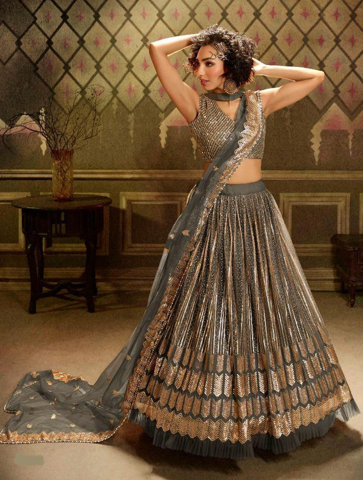 Grey Soft Net Party Wear Lehenga Set + Gold Plated Necklace Set with pearls + Silver beaded Flapover - Rent